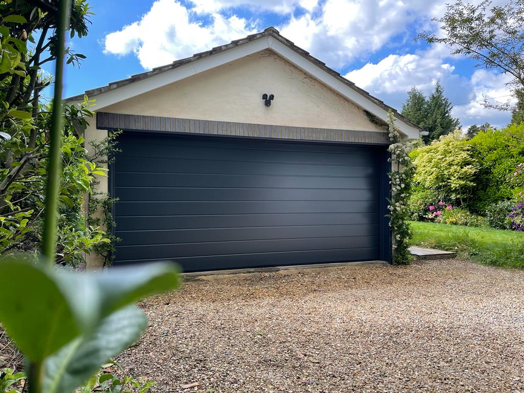 Detached garage building with sectional garage door.