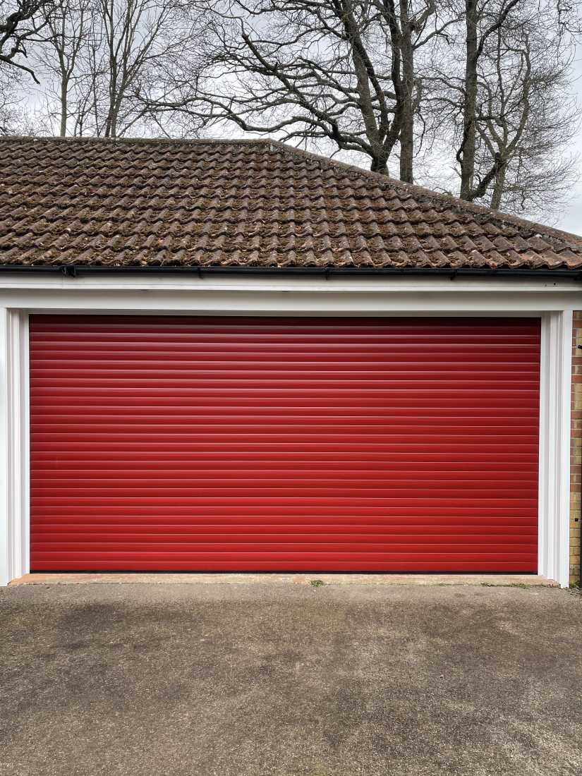 Newly fitted roller garage door in ruby red.