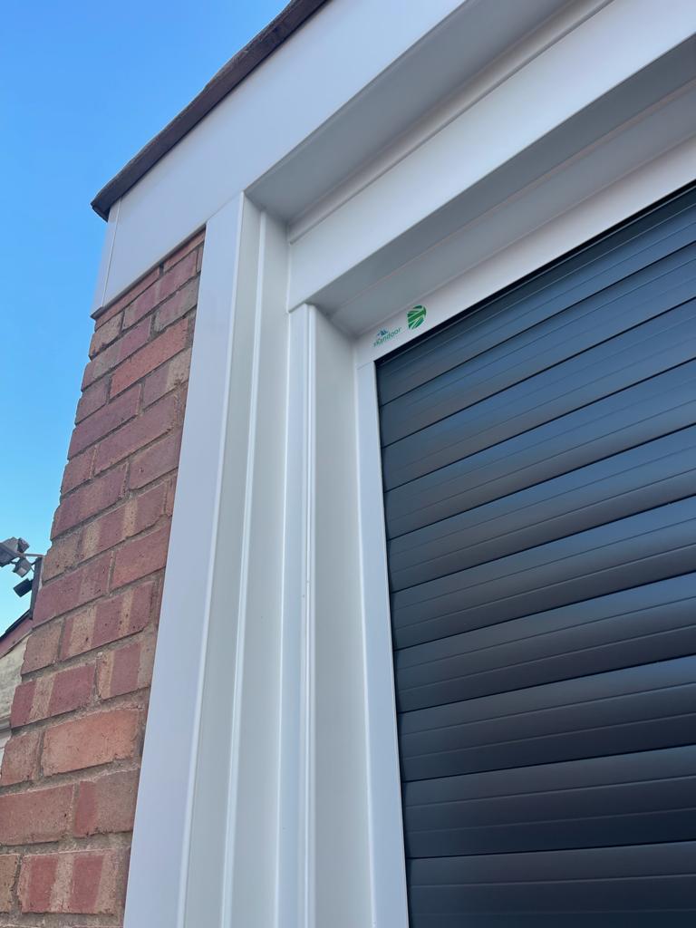 Corner of a garage frame with Skandoor sticker.