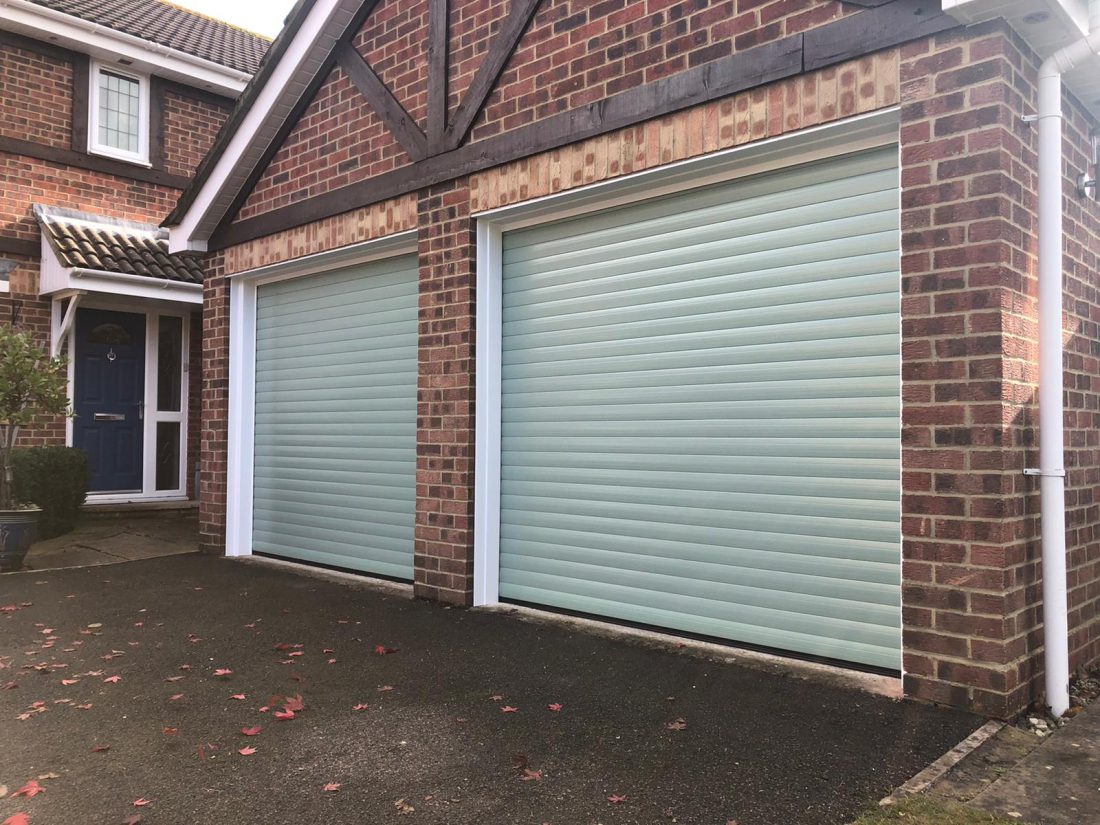 Detached garage with roller garage doors in Chartwell green.