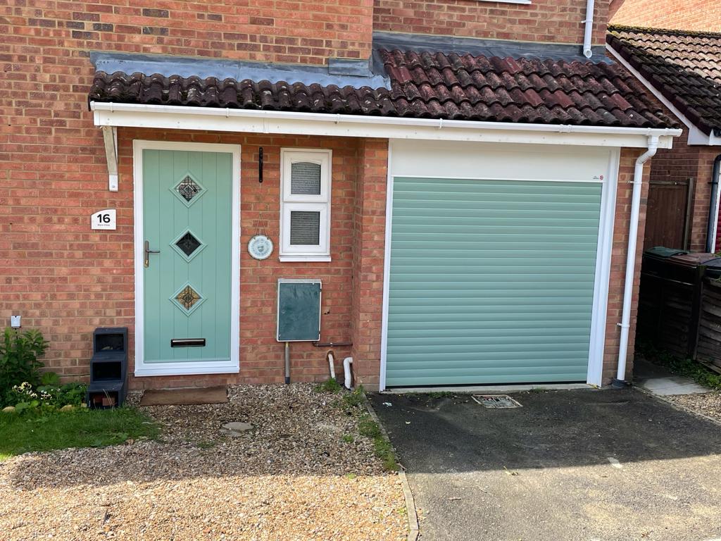 Composite front door matching roller garage door in Chartwell Green.