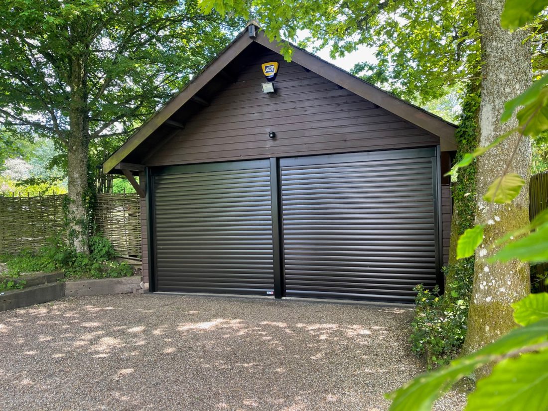 After photo of a garage that has been fitted with brand new roller garage doors in black.