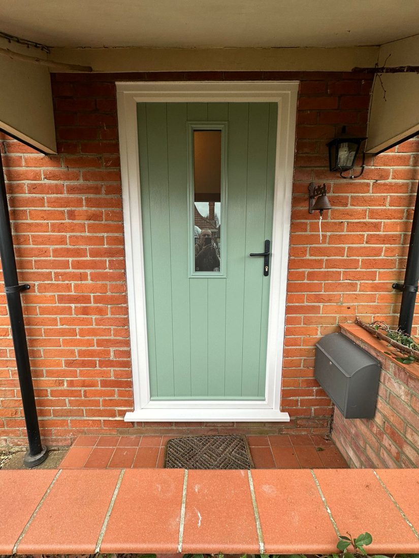 Composite front door with feature window in Chartwell Green.