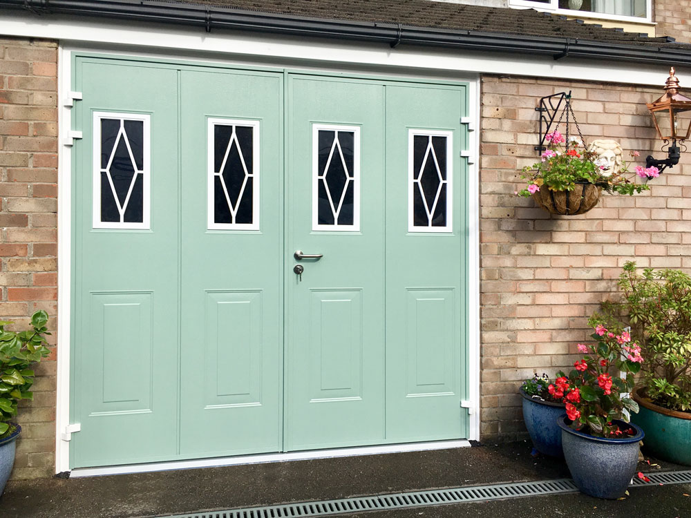 Side hinged garage door with feature windows in Chartwell Green.