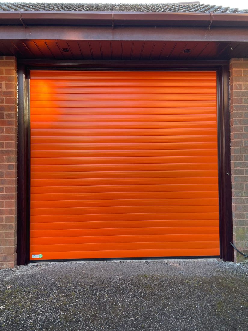 Roller garage door in tangerine colour.