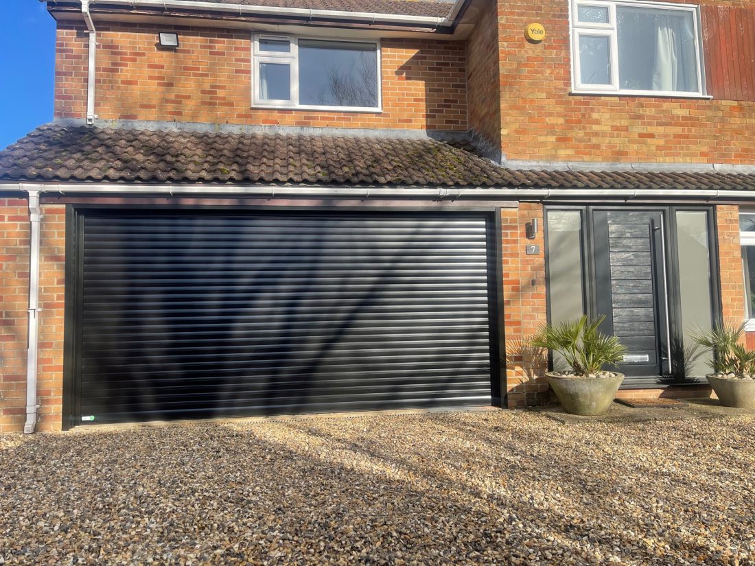 Substantial family home fitted with a sectional garage door and composite front door.